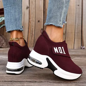 Nahaufnahme weinroter Keilsneaker mit dicker Luftkissensohle und Klettverschluss-Detail