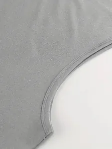 Close-up of double-stitched armhole on a grey men's sports running tank top vest.