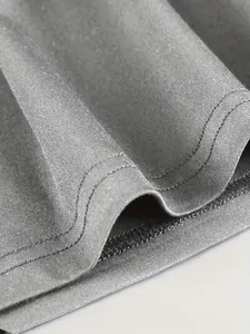 Macro shot of durable double-stitched hem on a grey athletic tank top fabric