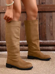 Women's suede knee-high fashion boots with low heels in tan color, chic outdoor style.