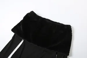 Detailed view of the soft faux fur trim on this black off-shoulder winter jumpsuit.