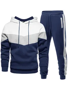 Detailed view of men's tri-color patchwork hoodie and sweatpants set in navy and white.