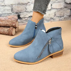 Light blue suede ankle boots for women with double side zippers and chunky heels.