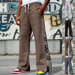 Side view of hip-hop straight-leg pants featuring snap buttons and paisley print details