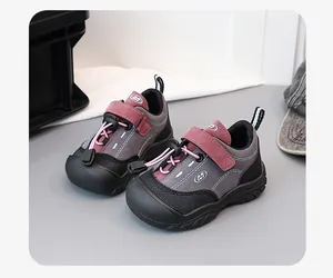 Close-up of durable children's outdoor sports shoes in grey and burgundy color mix