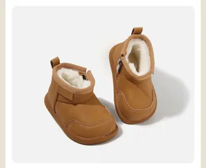 Classic tan baby snow boots featuring warm white faux fur lining and side zipper