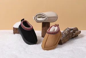 Detail view of colorful toddler snow boots with warm faux fur lining on a winter snow display