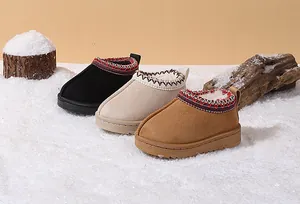 Cozy kids snow boots in three colors displayed on artificial snow background