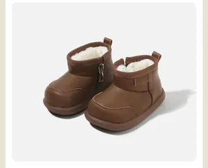 Close-up detail of warm brown baby snow boots with thick white faux fur lining