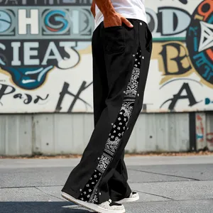Side view of men's hip-hop pants with bandana print side panels and snap buttons.
