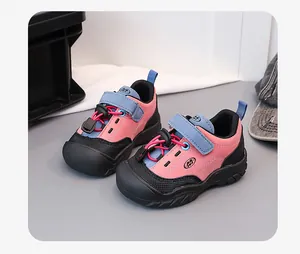 Detailed view of pink and blue children's sports shoes with velcro and soft sole design