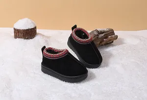 Close-up of black toddler snow boots with cozy warm lining displayed on artificial snow