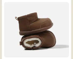 Detailed view of warm brown baby snow boots featuring soft white faux fur lining and leather texture