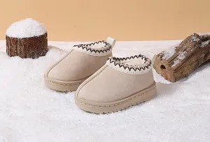 Detailed macro view of warm beige children's winter snow boots with plush lining