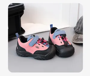 Close-up of pink and black children's hiking shoes with secure toggle laces.