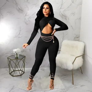 Detail view of a sexy black long-sleeved jumpsuit with a cross-front cutout design