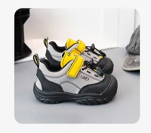 Detail view of stylish grey and yellow kids sports shoes with Velcro straps