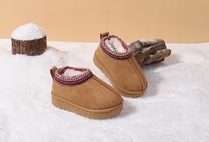 Detail of warm chestnut brown toddler snow boots with plush faux fur lining and woven collar