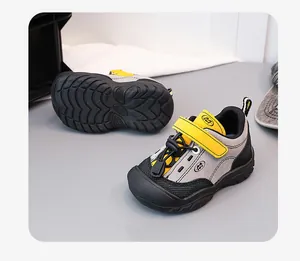 Detailed view of children's hiking shoes with soft non-slip soles and mesh upper.