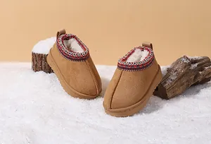 Detail view of brown toddler snow boots with warm fur lining and embroidered collar