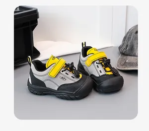 Detailed view of yellow and gray children's hiking shoes featuring velcro straps and soft soles.