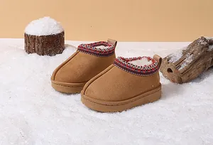 Warm children's snow boots with embroidered collar, soft fleece lining, and winter scene.