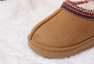 Detailed view of children's warm snow boots with soft plush lining and embroidery