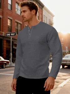 Detail of men's dark grey heavy long-sleeved Henley shirt with jacquard texture