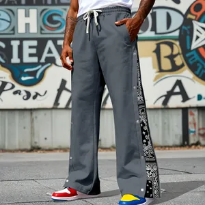 Detail view of men's hip-hop sweatpants with side snap buttons and bandana panel