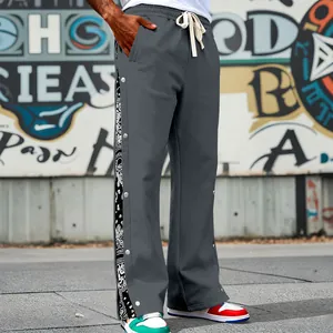 Detail of men's hip-hop sweatpants with paisley pattern and side snap buttons