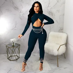 Close-up of sexy long sleeve cross cutout jumpsuit with chain belt and lace-up ankles