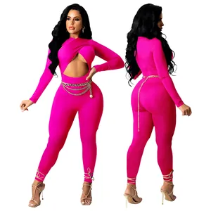 Detailed view of a sexy hot pink crossover jumpsuit with a gold chain belt detail