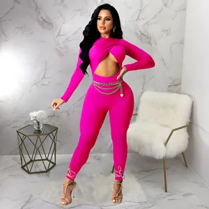 Sexy hot pink long sleeve jumpsuit featuring front cutout and waist chain detail