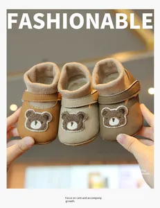 Close-up of baby walking shoes with cute embroidered bear faces and knit cuffs.