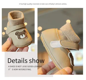 Close-up showing the soft fleece lining and cute bear motif of these baby winter shoes