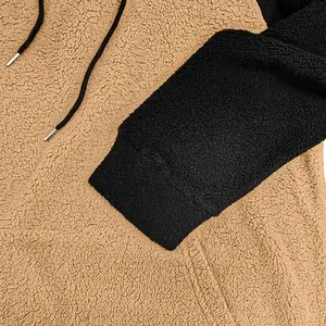 Nahaufnahme der weichen Fleece-Textur und des Color-Block-Designs des Herren-Kapuzenpullovers.