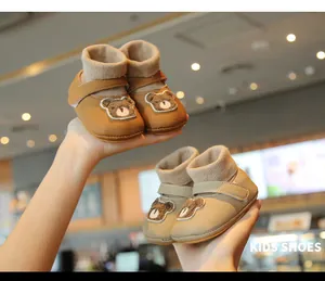 Two pairs of warm baby bear walking shoes in brown and beige colors