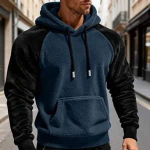 Nahaufnahme eines blau-schwarzen Herren-Fleece-Hoodies mit Raglanärmeln und weichem Stoff.