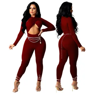 Sexy burgundy long sleeve jumpsuit featuring crossover front cutout and chain belt detail.