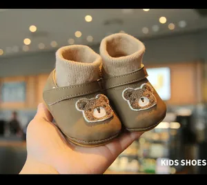 Detailed view of warm brown fleece-lined baby walking shoes with cute bear pattern