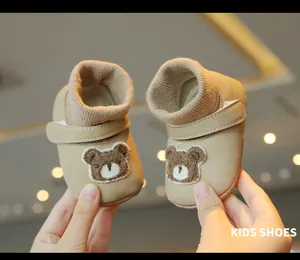 Detail view of soft-sole baby winter shoes with cute bear embroidery patch.