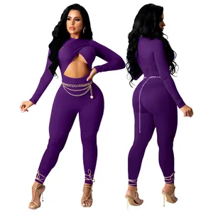 Sexy purple long sleeve jumpsuit with front cutout, gold chain belt, and lace-up hem
