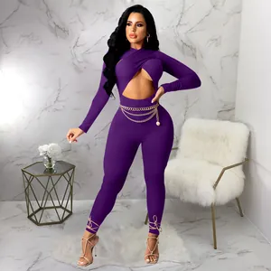 Detailed view of sexy purple jumpsuit featuring cross cutout and golden chain belt.
