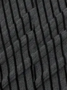 Macro detail of dark gray textured fabric with black vertical stripes for women's tops.