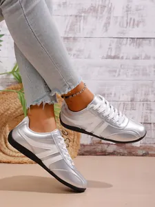 Stylish metallic silver women's casual sneakers styled with denim jeans and an anklet
