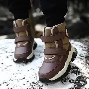Warm children's high-top outdoor snow boots with double hook-and-loop straps on snow