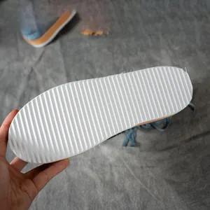 Detail view of the white anti-slip corrugated outsole of Western-style fringe boots.