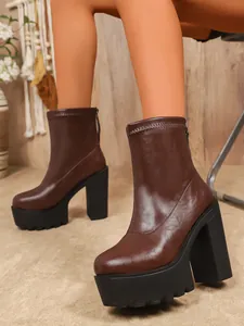 Close-up detail of dark brown chunky platform ankle boots with thick high heels