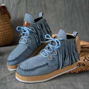 Detailed view of blue suede fringe ankle boots with Western cowboy style and thick sole