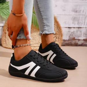Black and white low-top casual sneakers for women with stylish side stripes and non-slip soles